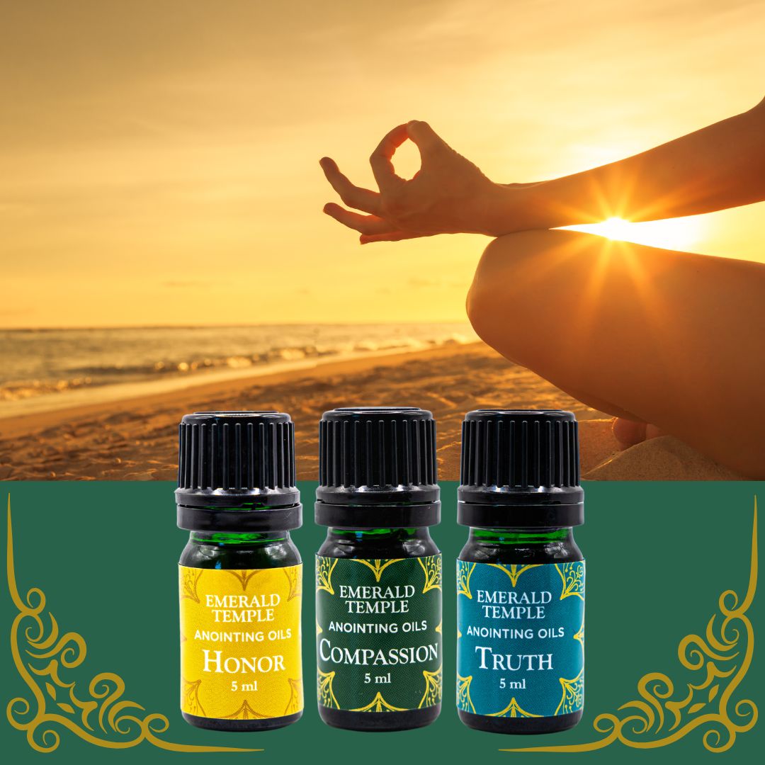 Three bottles of Emerald Temple anointing oils, each labeled with different attributes such as Honor, Compassion, and Truth, displayed against a backdrop of a person meditating by the beach.